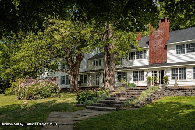 rear view of house with a lawn