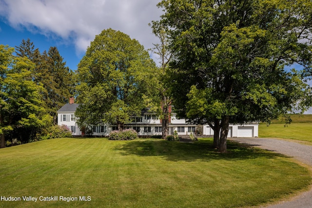 view of front of property featuring a garage and a front yard