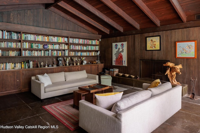 living room with lofted ceiling with beams, dark tile patterned floors, wood ceiling, and wooden walls