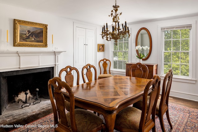 dining area featuring a healthy amount of sunlight, dark hardwood / wood-style flooring, and crown molding