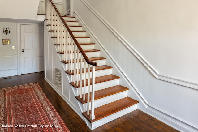 stairs featuring hardwood / wood-style flooring