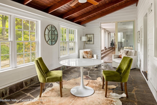 sunroom with vaulted ceiling with beams, ceiling fan, plenty of natural light, and wood ceiling