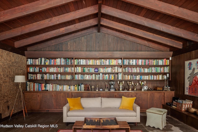 living area with lofted ceiling with beams, wood walls, and wooden ceiling