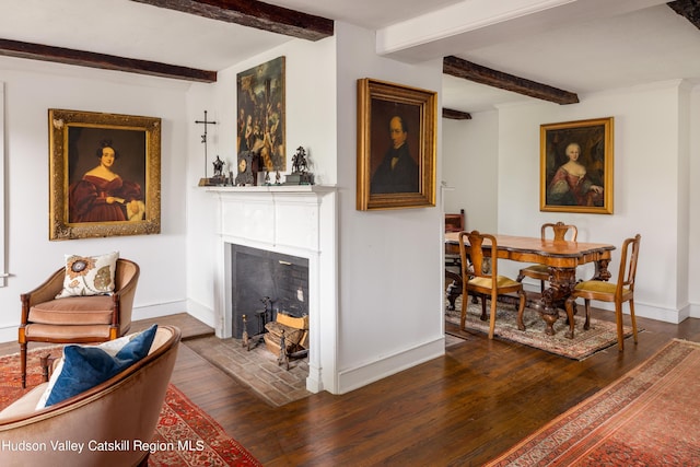 interior space with beamed ceiling and dark hardwood / wood-style floors