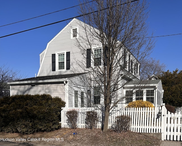 colonial inspired home with a fenced front yard