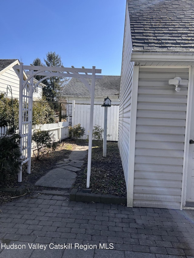 view of yard featuring a pergola and fence