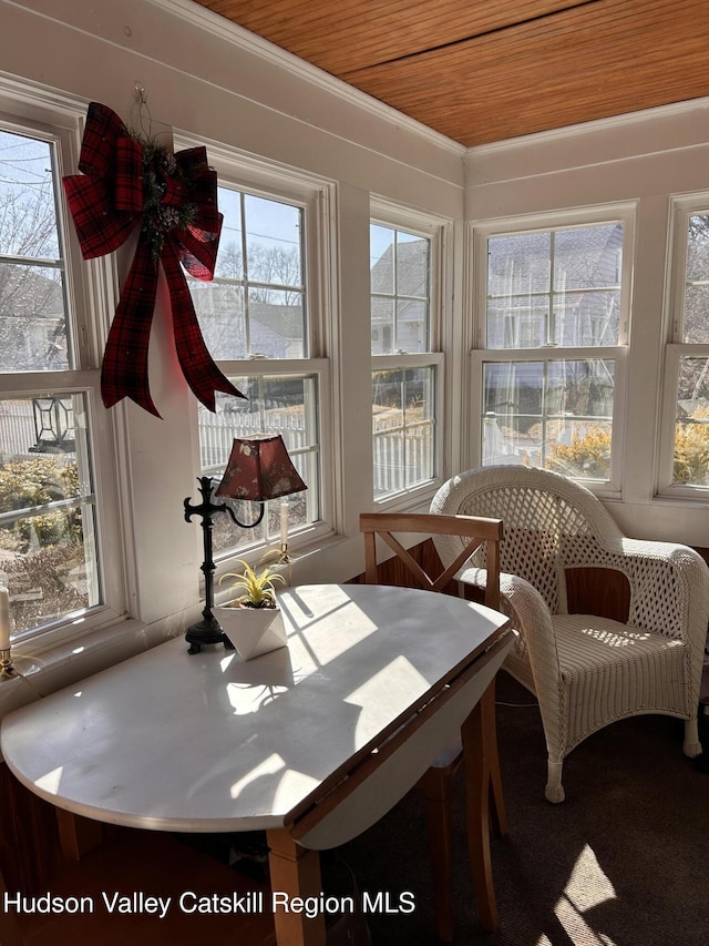 sunroom with plenty of natural light and wooden ceiling