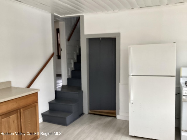 stairway with hardwood / wood-style floors