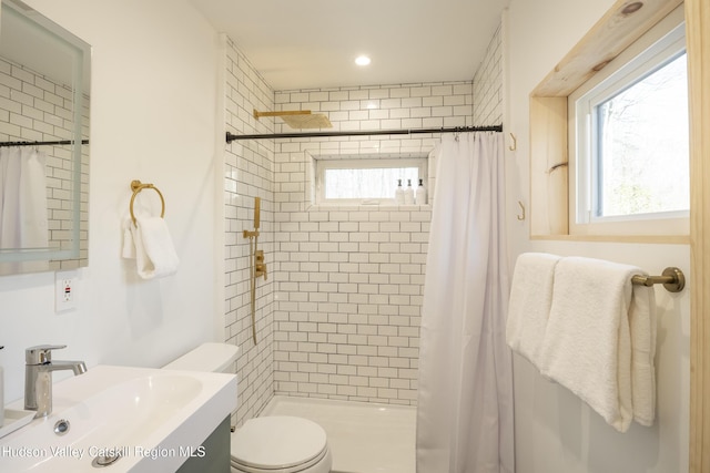 full bath with toilet, a wealth of natural light, and a stall shower