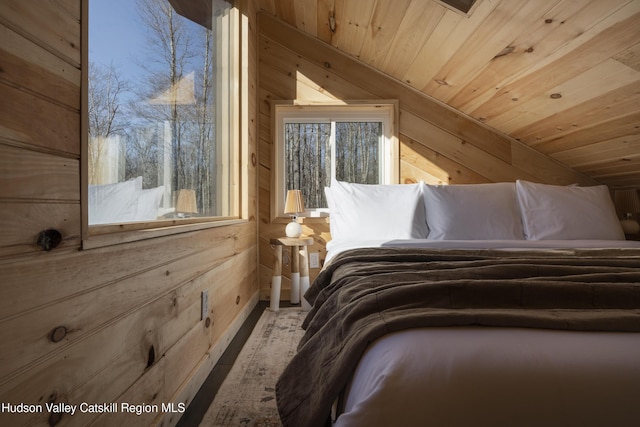 unfurnished bedroom featuring wooden walls and wooden ceiling