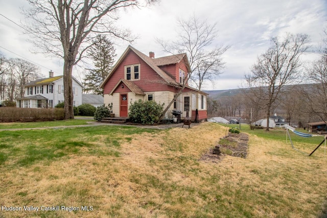 22 Hill St, Napanoch, NY 12458 - view of front facade with a chimney and a front yard