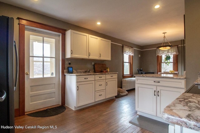 22 Hill St, Napanoch, NY 12458 - kitchen featuring radiator, freestanding refrigerator, white cabinets, hardwood / wood-style flooring, and recessed lighting