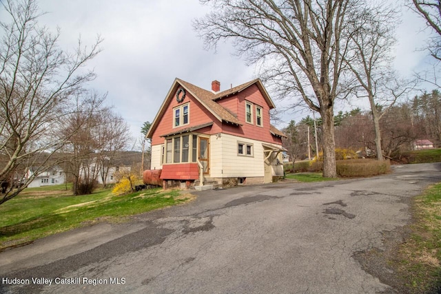 22 Hill St, Napanoch, NY 12458 - view of home's exterior with a chimney and asphalt driveway