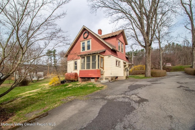22 Hill St, Napanoch, NY 12458 - view of front of home featuring a chimney, oil tank, a sunroom, and driveway