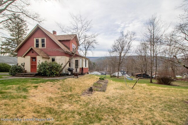 22 Hill St, Napanoch, NY 12458 - view of side of home featuring a chimney and a lawn