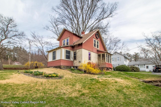 22 Hill St, Napanoch, NY 12458 - view of side of property featuring a sunroom, a yard, and a chimney