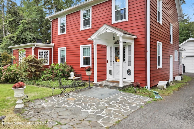 colonial inspired home featuring a patio