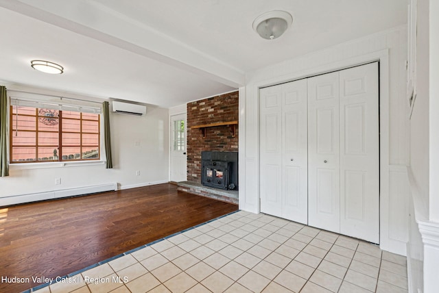 6 Stevens Ct, Saugerties, NY 12477 - unfurnished living room with light tile patterned flooring, a wall mounted air conditioner, baseboard heating, and a fireplace
