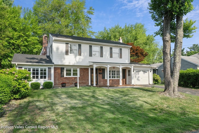 6 Stevens Ct, Saugerties, NY 12477 - view of front of home featuring a chimney, a porch, an attached garage, brick siding, and a front yard