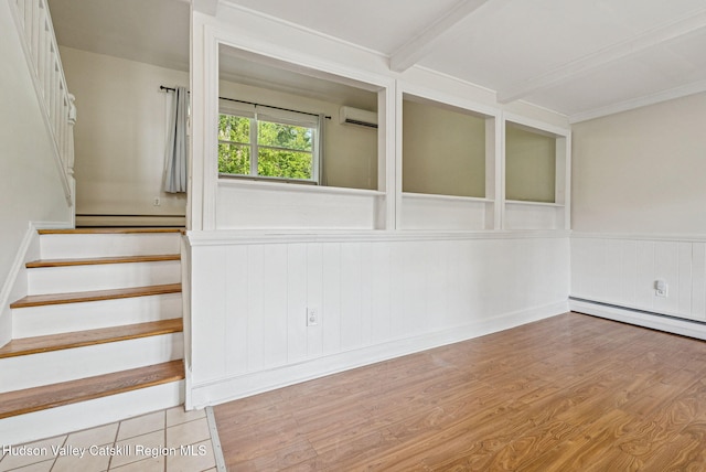 6 Stevens Ct, Saugerties, NY 12477 - spare room featuring an AC wall unit, stairs, wood finished floors, a baseboard heating unit, and a wainscoted wall