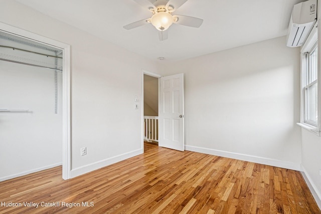 6 Stevens Ct, Saugerties, NY 12477 - unfurnished bedroom featuring a wall mounted AC, light wood-type flooring, baseboards, a closet, and ceiling fan