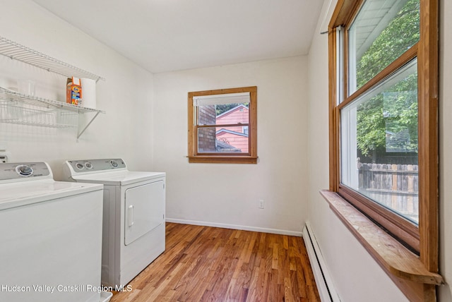 6 Stevens Ct, Saugerties, NY 12477 - washroom featuring washer and dryer, baseboard heating, light wood-type flooring, and baseboards