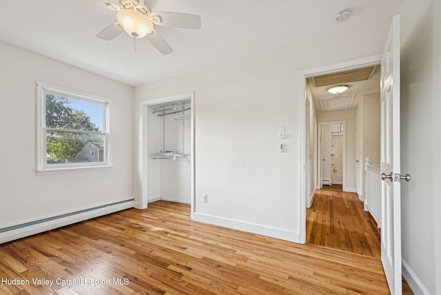 6 Stevens Ct, Saugerties, NY 12477 - unfurnished bedroom with attic access, light wood finished floors, a baseboard radiator, baseboards, and a closet