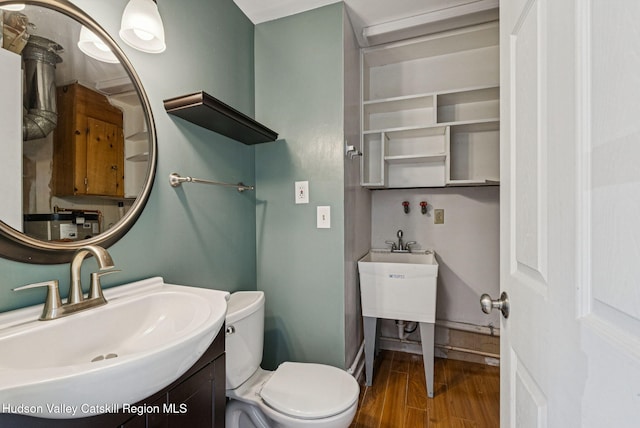 6 Stevens Ct, Saugerties, NY 12477 - bathroom with wood finished floors, toilet, vanity, and baseboards