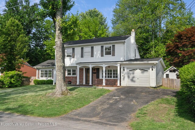 6 Stevens Ct, Saugerties, NY 12477 - traditional-style home with a garage, covered porch, a chimney, asphalt driveway, and brick siding