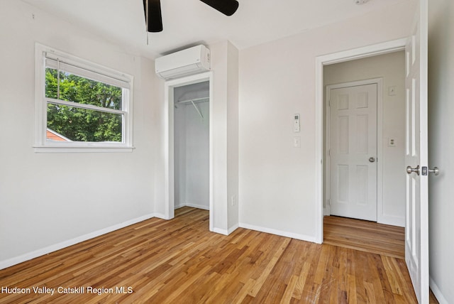 6 Stevens Ct, Saugerties, NY 12477 - unfurnished bedroom with a wall mounted air conditioner, baseboards, light wood-style floors, a closet, and ceiling fan