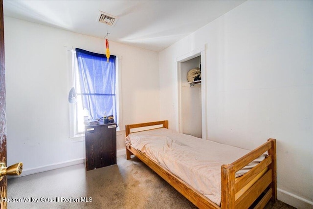 bedroom featuring baseboards and visible vents