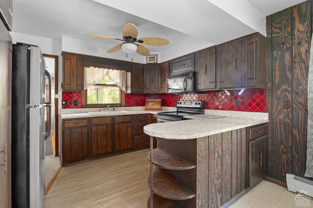 46 Fox Ln, Catskill, NY 12015 - kitchen featuring appliances with stainless steel finishes, open shelves, light countertops, a peninsula, and baseboard heating