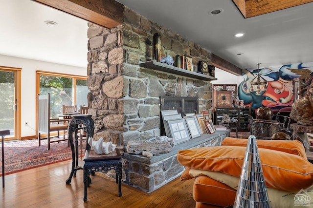 7951 State Route 22, Copake, NY 12516 - living room featuring a stone fireplace, wood finished floors, baseboards, recessed lighting, and beam ceiling