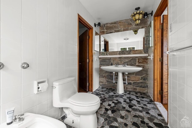 7951 State Route 22, Copake, NY 12516 - bathroom with tile walls, toilet, a sink, and a bidet