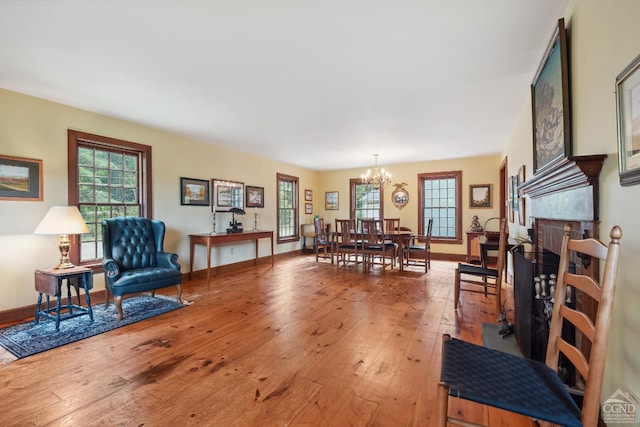 2205 County Route 5, Canaan, NY 12029 - living room featuring a chandelier, light wood-style floors, and baseboards