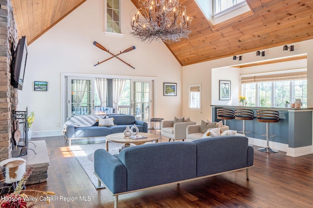 living room with high vaulted ceiling, dark wood-type flooring, a wealth of natural light, and wooden ceiling