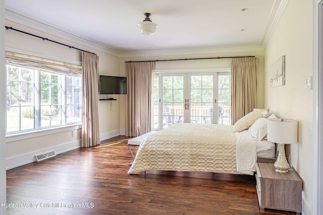 bedroom featuring multiple windows, access to outside, dark hardwood / wood-style floors, and french doors