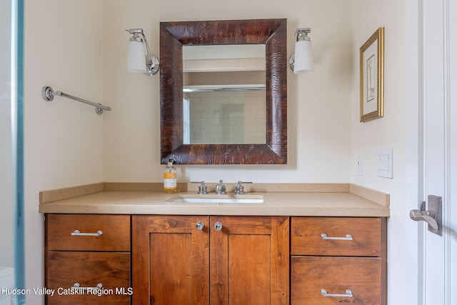 bathroom featuring vanity and a shower with shower door