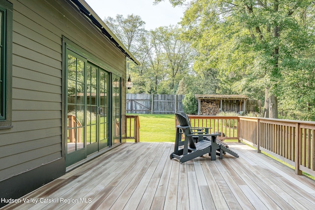 wooden terrace with a lawn