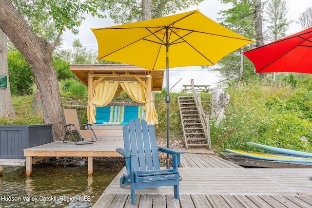 wooden terrace featuring a water view