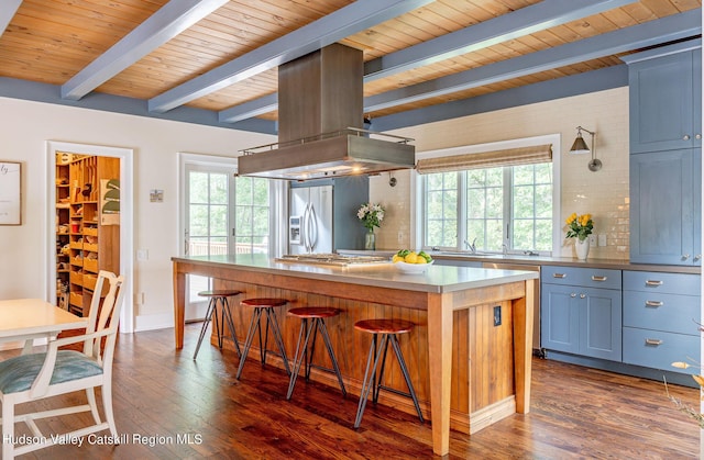 kitchen with a breakfast bar area, appliances with stainless steel finishes, dark hardwood / wood-style flooring, a kitchen island, and island exhaust hood