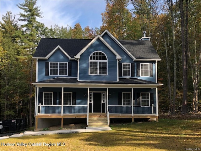 view of front of property with covered porch and a front yard