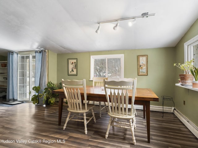 dining room featuring dark wood-type flooring and baseboards