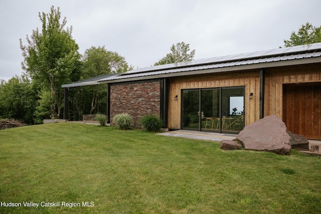 1199 W Highland Rd, Hobart, NY 13788 - rear view of house with roof mounted solar panels, a yard, and a metal roof