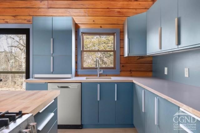 269 Church Ave, Germantown, NY 12526 - kitchen with dishwasher, blue cabinets, a sink, range, and wooden walls
