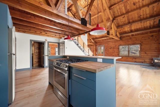 269 Church Ave, Germantown, NY 12526 - kitchen featuring stainless steel gas range, open floor plan, wood ceiling, blue cabinetry, and light wood-style floors