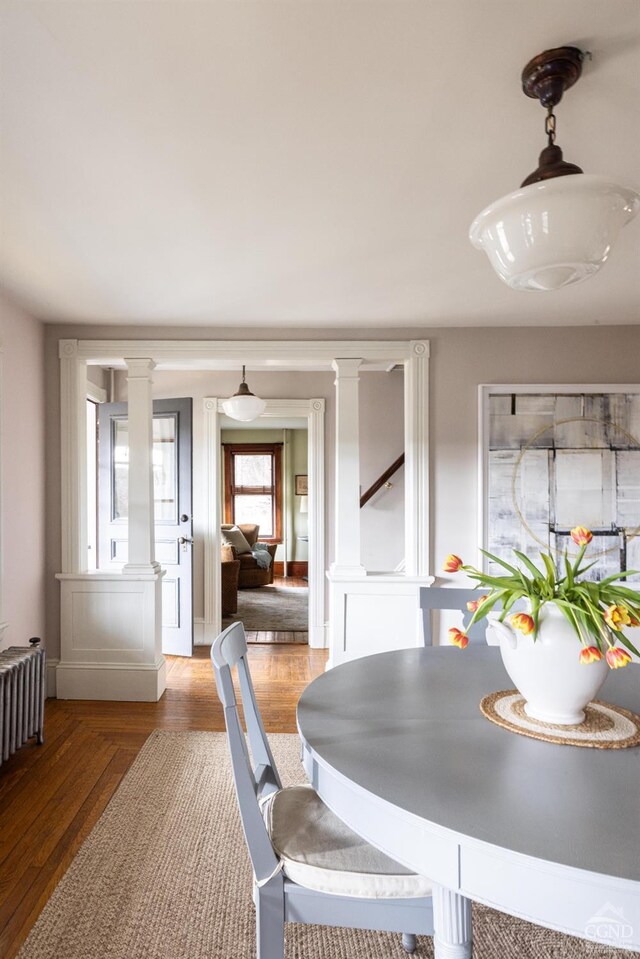 1301 County Route 7, Ancram, NY 12502 - dining area with decorative columns, radiator heating unit, and wood finished floors