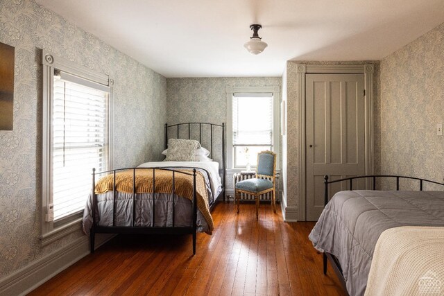 1301 County Route 7, Ancram, NY 12502 - bedroom with wood-type flooring, wallpapered walls, and multiple windows