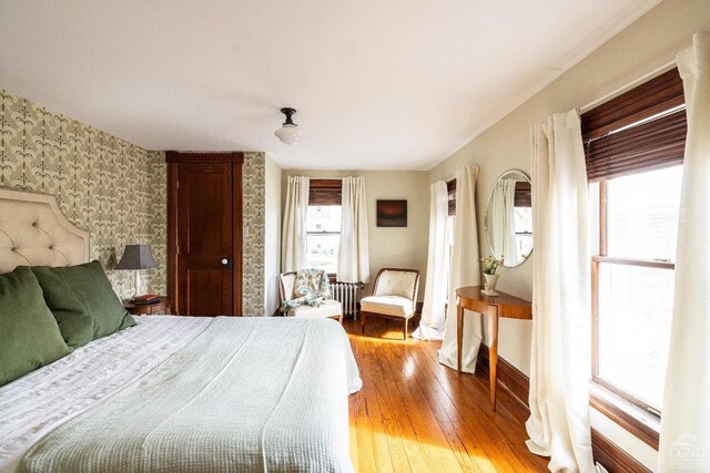 1301 County Route 7, Ancram, NY 12502 - bedroom with wallpapered walls, light wood-type flooring, radiator, and baseboards