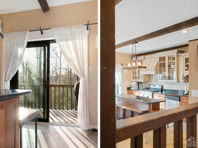 23 Townhouse Ln Unit D 1, Windham, NY 12496 - interior space featuring stainless steel appliances, beam ceiling, healthy amount of natural light, and glass insert cabinets